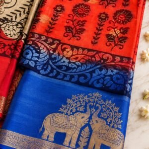 Traditional red and royal blue designer saree featuring intricate golden elephant motifs and an elegant decorative border.